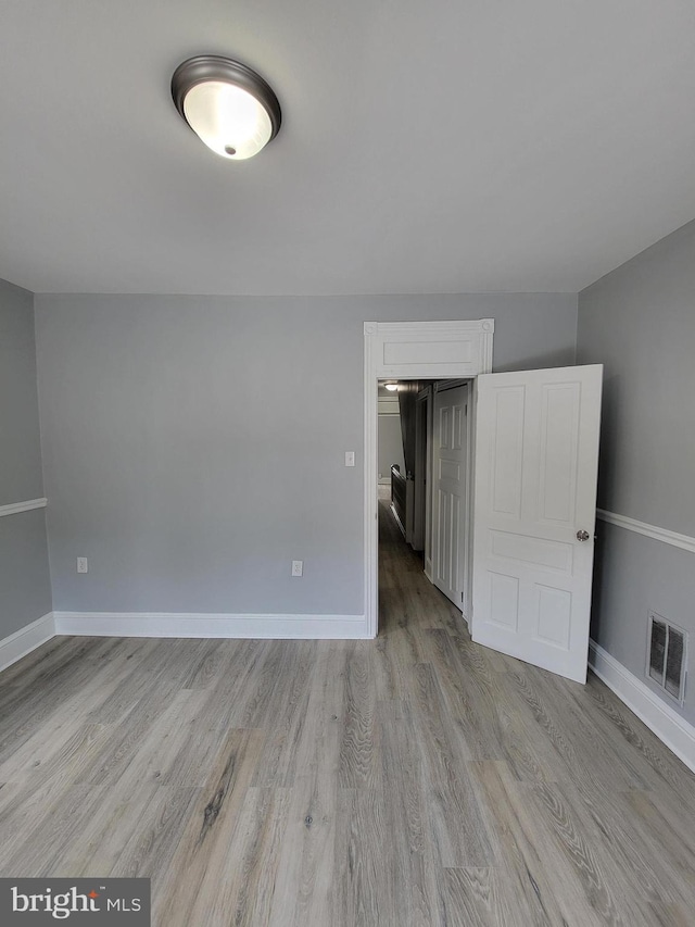 spare room with light wood-type flooring