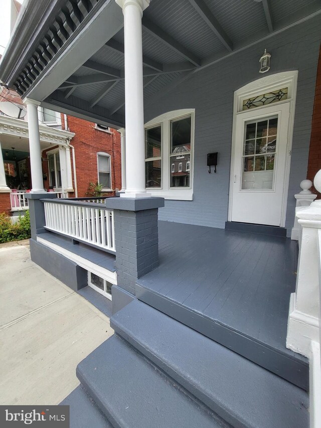 doorway to property featuring covered porch