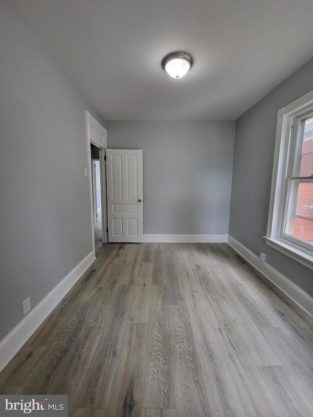 unfurnished room with light hardwood / wood-style flooring