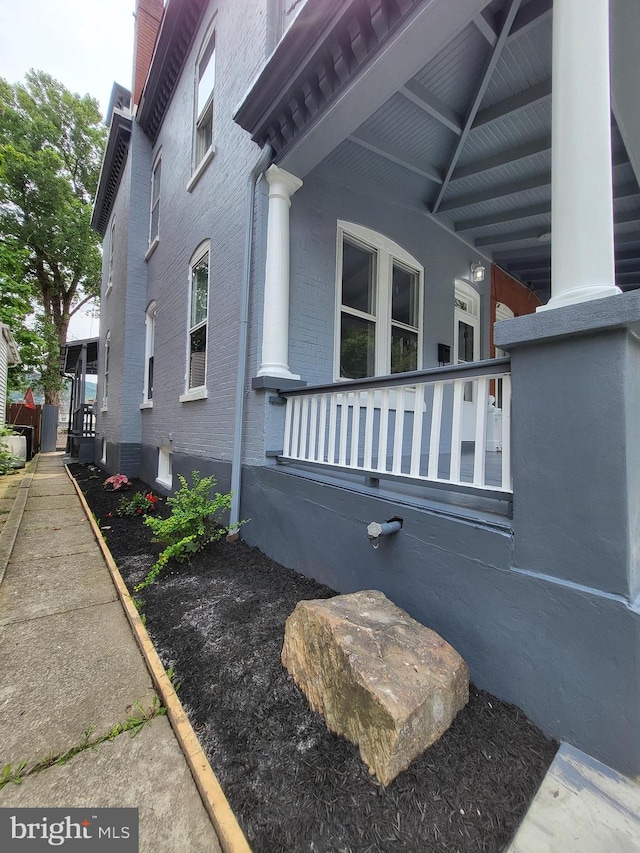 view of side of home with covered porch