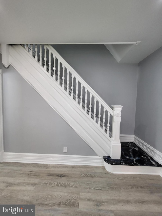 stairs with wood-type flooring