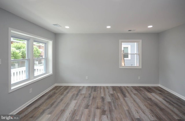 unfurnished room with hardwood / wood-style flooring