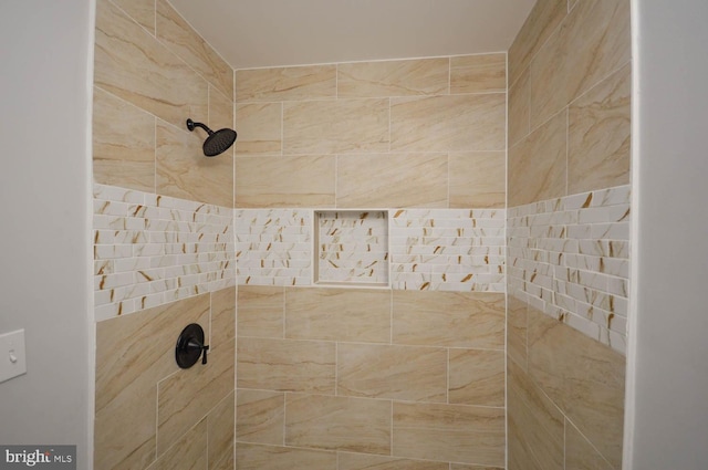 interior details featuring a tile shower