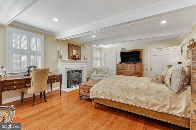 bedroom with crown molding, light hardwood / wood-style flooring, and beam ceiling