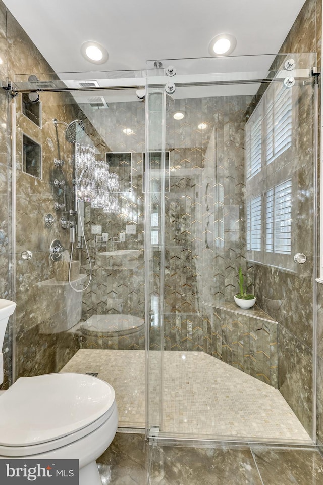 bathroom with toilet and walk in shower