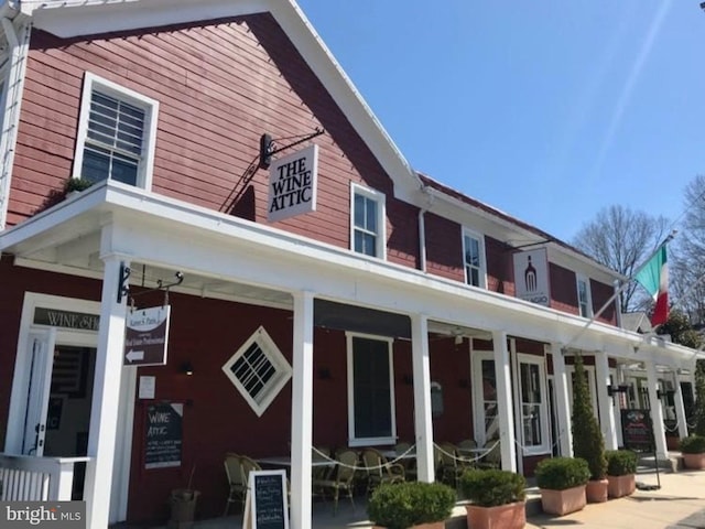 rear view of property featuring a porch