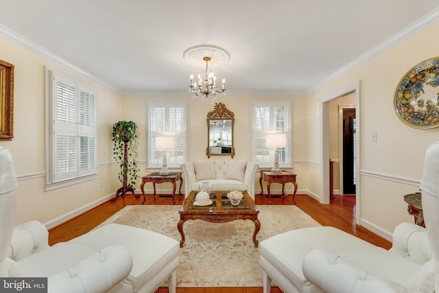 living area with a chandelier, ornamental molding, and light hardwood / wood-style floors