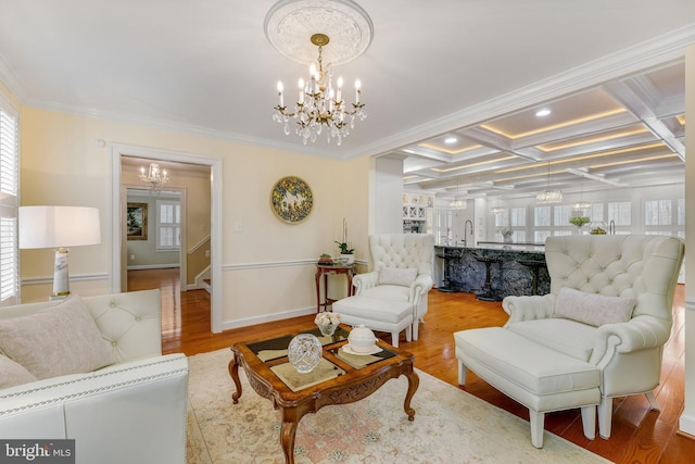 living room with a notable chandelier, beamed ceiling, hardwood / wood-style floors, coffered ceiling, and ornamental molding