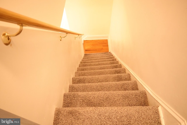 stairway featuring hardwood / wood-style flooring