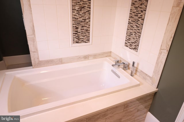 bathroom with tiled tub