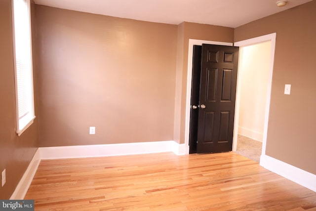 empty room with light hardwood / wood-style flooring