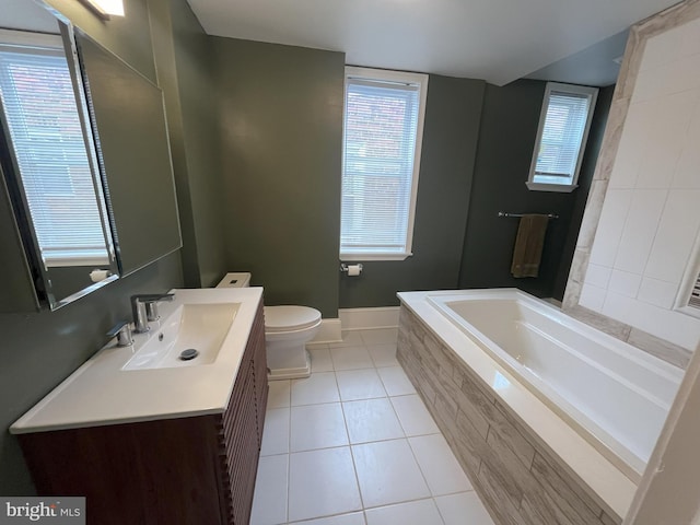 bathroom featuring a relaxing tiled tub, tile patterned flooring, toilet, and vanity