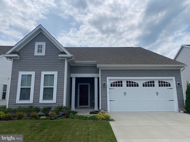 view of front of property with a front lawn and a garage