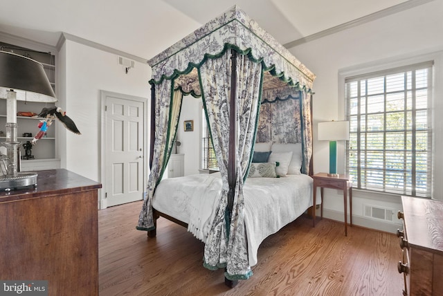 bedroom featuring wood-type flooring and ornamental molding