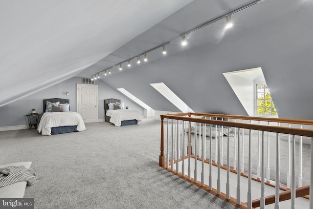 bedroom with carpet floors and lofted ceiling with skylight