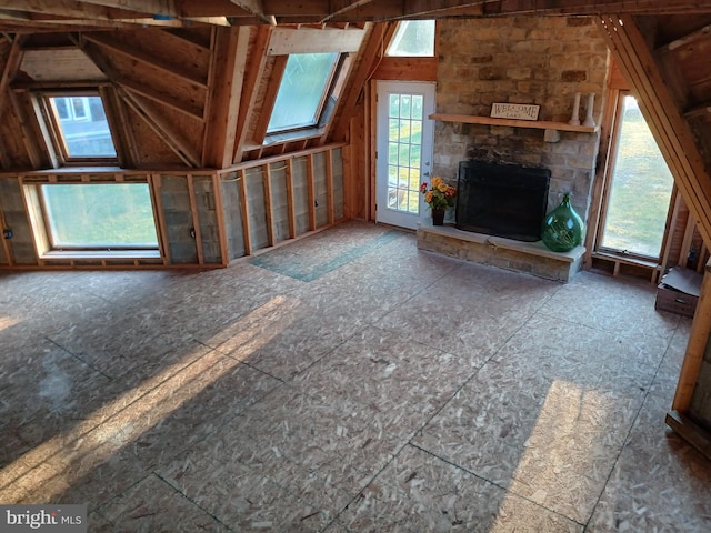 unfurnished living room featuring a fireplace and vaulted ceiling