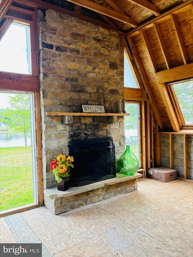 unfurnished living room featuring a fireplace and vaulted ceiling