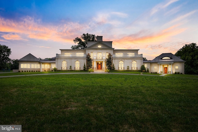 view of front of property featuring a yard and french doors