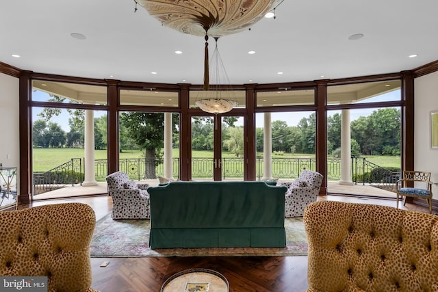 living room featuring expansive windows, dark parquet flooring, and plenty of natural light