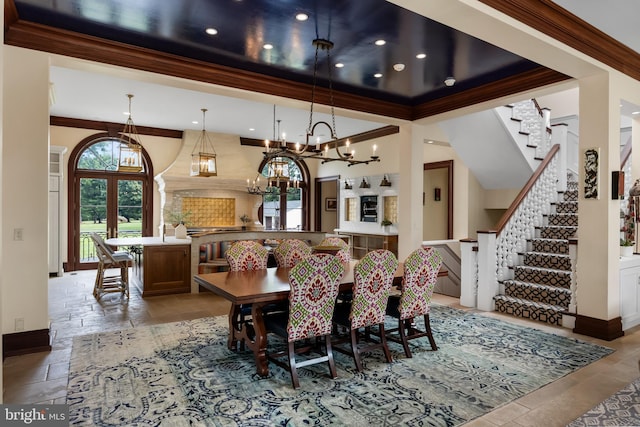 dining area featuring ornamental molding and a high ceiling