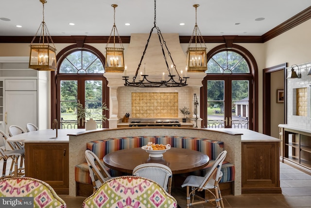 dining room with dark tile patterned floors, crown molding, and french doors