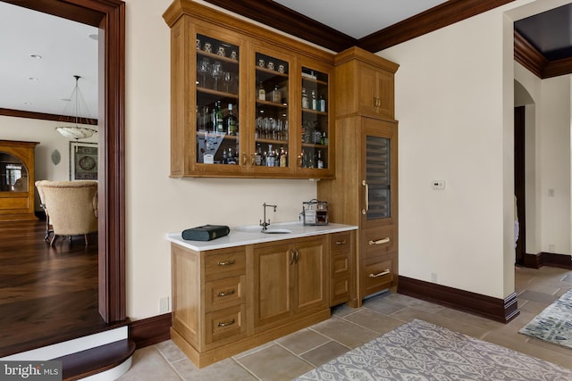 bar featuring ornamental molding and light tile patterned flooring