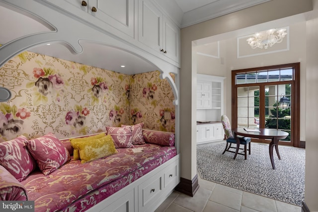 bedroom featuring french doors, crown molding, an inviting chandelier, and light tile patterned floors