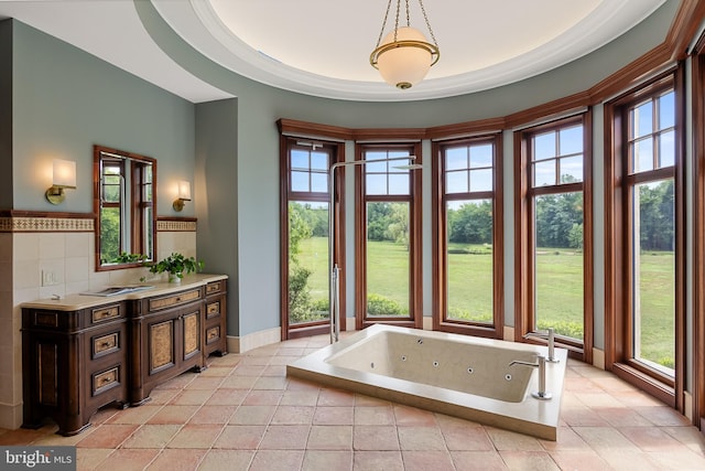 bathroom featuring a bathing tub, vanity, and tile patterned floors