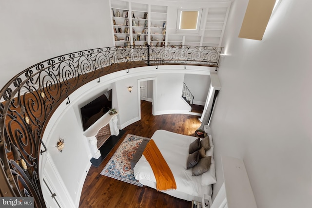 staircase featuring a high ceiling and hardwood / wood-style floors