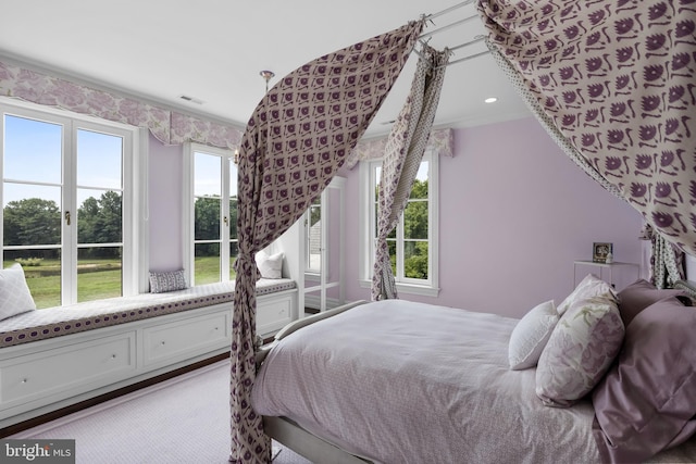 carpeted bedroom with ornamental molding