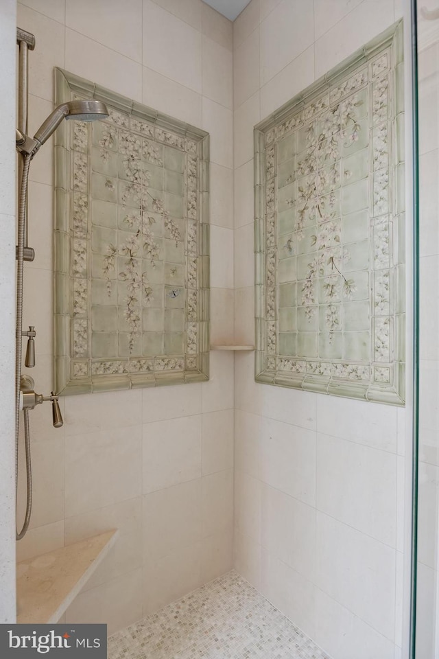 bathroom with tiled shower