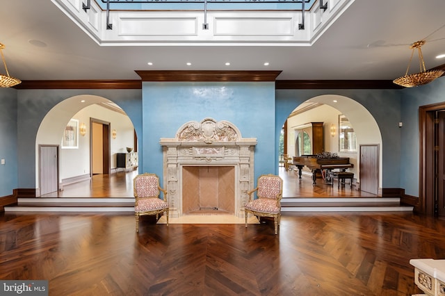 interior space featuring crown molding, a high end fireplace, and dark parquet floors