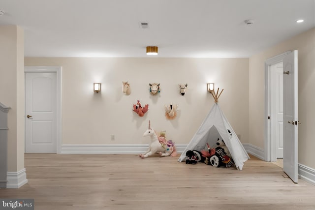 playroom with light hardwood / wood-style floors