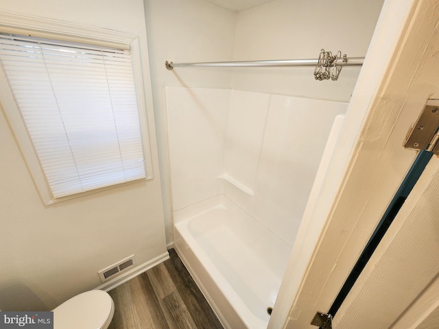 bathroom with hardwood / wood-style flooring and toilet