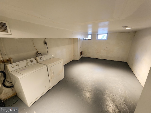 clothes washing area featuring separate washer and dryer