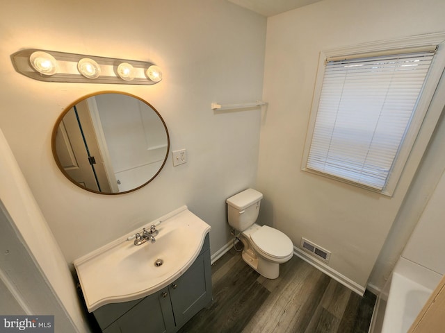 bathroom featuring vanity, hardwood / wood-style flooring, and toilet