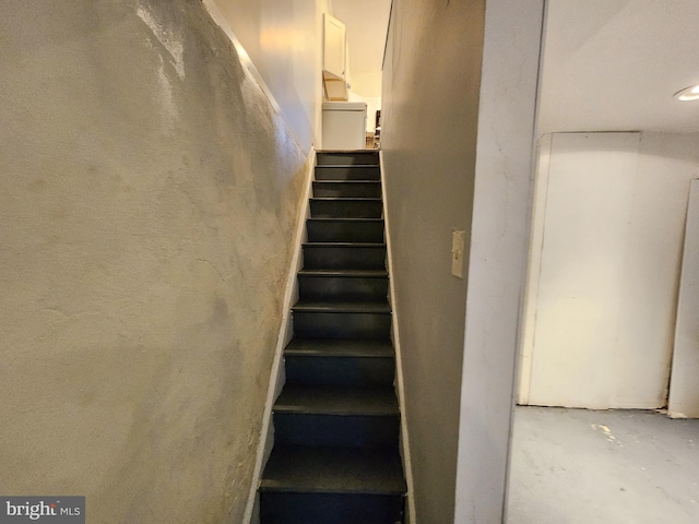 stairway with concrete flooring