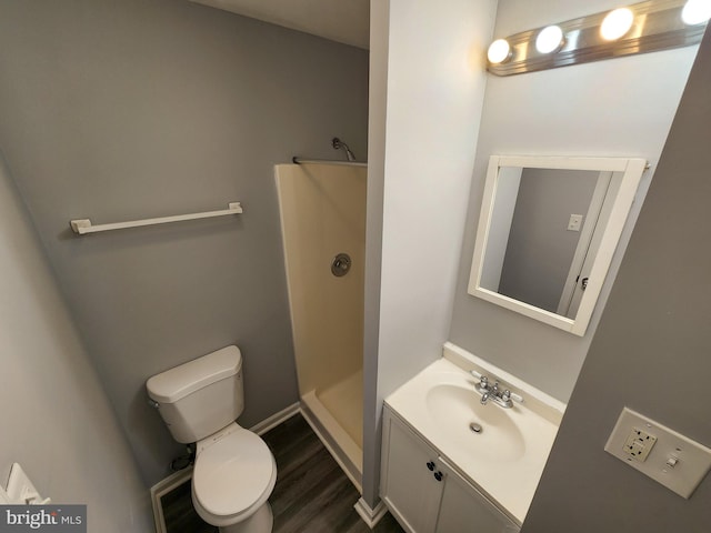 bathroom featuring walk in shower, wood-type flooring, toilet, and vanity