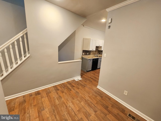 hall featuring ornamental molding and wood-type flooring