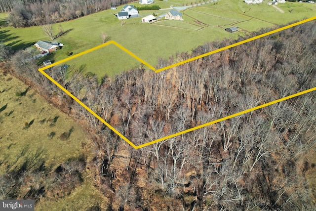 birds eye view of property with a rural view