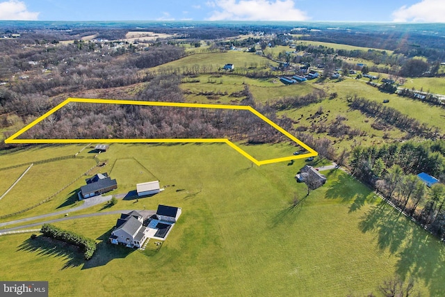 birds eye view of property with a rural view