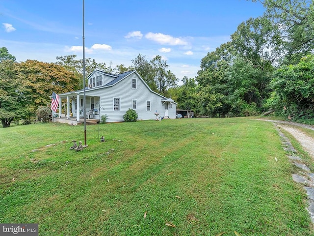 view of yard featuring covered porch