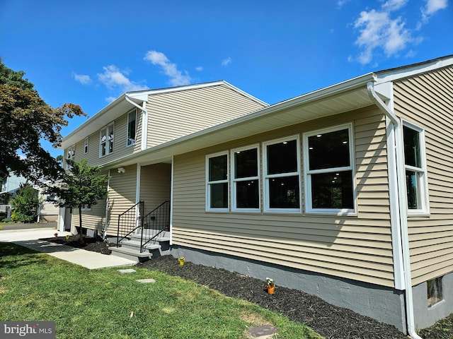 view of property exterior with a yard