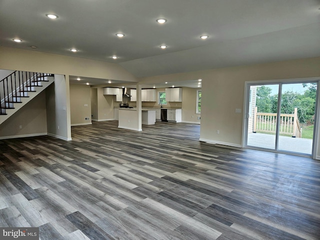 unfurnished living room featuring lofted ceiling and dark hardwood / wood-style floors