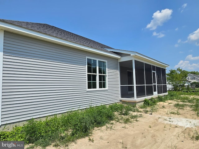 view of side of home with a sunroom