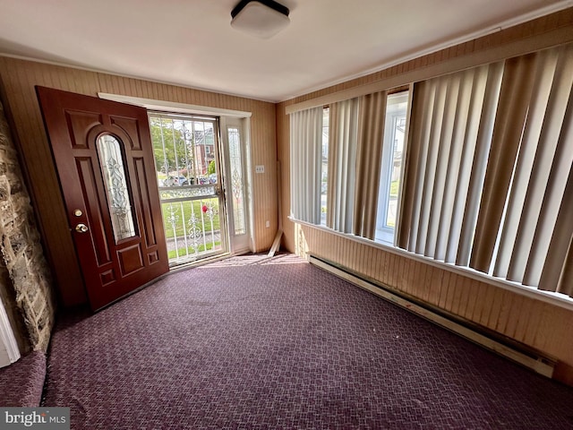 unfurnished sunroom with a baseboard heating unit