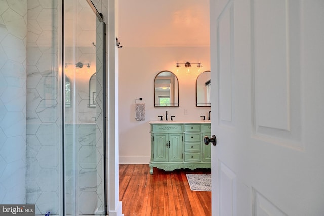 bathroom featuring vanity, an enclosed shower, and hardwood / wood-style flooring