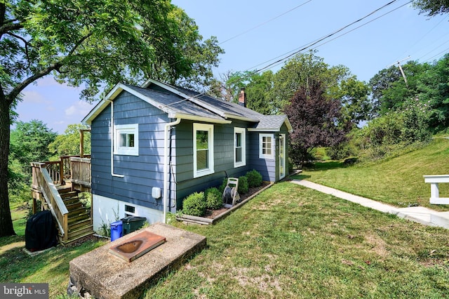 exterior space featuring a lawn and a wooden deck