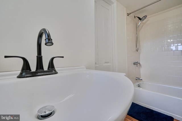 bathroom featuring sink and washtub / shower combination