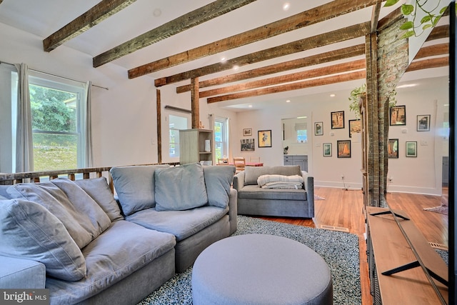 living room with beam ceiling and wood-type flooring